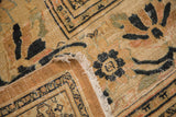 Antique Doroksh carpet's worn pile at corner, revealing exposed foundation and dark Lily motifs.