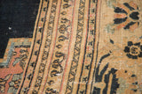 Antique Doroksh carpet's blush and sand border with checkered Lily and vine motif, visible foundation.