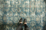 Worn texture of a distressed vintage Mahal rug, ocean blue and blush florals.