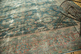 Distressed vintage Mahal carpet section with faded teal, rose, and ivory floral motifs and border.