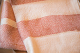 Handwoven sienna and cream striped cotton dish towel, showing textile texture.