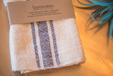 Handwoven Loomination cotton napkin detail with navy blue and cream striped texture.