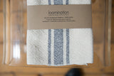 Loomination handwoven napkin with gray stripes and brown brand label.