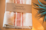 Sienna orange and cream striped handwoven cotton napkin with Loomination label.