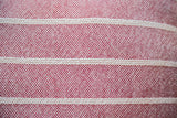 Woven cotton texture of striped wine red pillow with three cream bands.