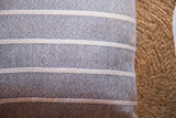 Hand-woven gray cotton pillow fabric with fine textured weave and cream stripes.