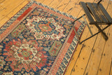 Vintage Seichor runner's geometric medallion, rectilinear flowers, indigo, red, green, tattered end.