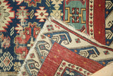 Hand-knotted Seichor rug foundation revealed, with visible wear and tattered corner.