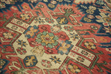 Hand knotted vintage Seichor rug detail: geometric medallion, rectilinear blossoming flowers.