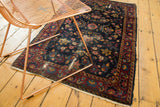 Vintage Persian Yezd rug corner, showing fringe and worn indigo floral vinery.