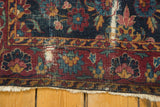 Vintage Yezd rug corner with cochineal border, indigo floral vinery field, ivory fringe, isolated etching.