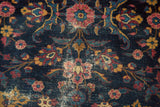 Vintage Persian Yezd rug detail: indigo field, delicate floral vinery, reds, golds, and foundation etching.