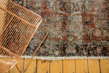 Hard tattered fringe, brick red and navy border of vintage Lilihan rug, with small hole.