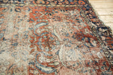Worn vintage Lilihan rug surface, brick red, navy, ivory vinery, foundation showing.