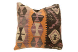Vintage Kilim Throw Pillow featuring geometric motifs in earth tones, rust orange, and lavender, 16x16 inches.