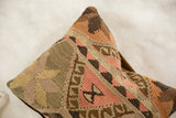Vintage Kilim pillow showcasing hand-woven texture and earthy geometric patterns in muted pinks.