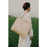 Square seagrass bag, natural beige, featuring a prominent woven texture.