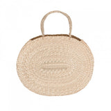 Upper view of the handwoven round seagrass bag, highlighting the sturdy handle and brown top trim.