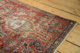 Low pile texture and exposed foundation of a ruby red and indigo blue antique Heriz runner.