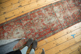 Long view of an antique Heriz runner, detailing its soft patina and mostly even wear.