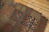 Exposed foundation and tattered edge of antique Turkmen rug with primitive geometric panels.