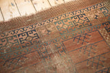 Geometric panel patterns, worn foundation, and tattered border of an antique Turkmen rug.