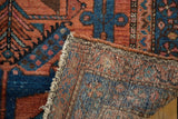 Vintage Hamadan rug's tightly woven foundation and geometric brick red and blue pile.