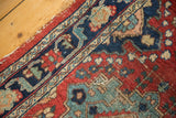 Traditional Persian Tabriz runner's navy border, cherry red field with low pile and edge wear.