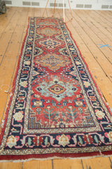 Vintage Persian Tabriz runner with red field, alternating medallions, and rich, worn texture.