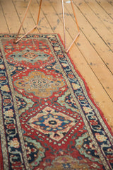 Vintage Tabriz runner detail showing cherry red field, alternating medallions, low pile, and side tatter.
