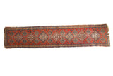 Vintage Gorevan runner with cherry red field, repeating geometric diamond guls, and blue, gold, green motifs, 2x9.5.