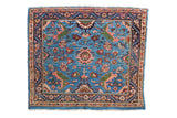 Fine Engelas square Persian rug with expressive vinery and floral blossoms on a sky blue field.