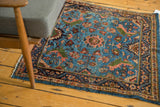 Vintage Persian Engelas rug styled to show its sky blue field and lush floral pattern.