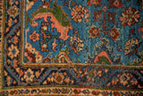 Corner detail of a collector Engelas rug showing full pile and pomegranate floral vinery.