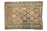 Antique Caucasian rug with allover starbursts and abstract animal figures. Charcoal, blue, and ivory tones.