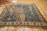 Storied corner of an antique Afshar rug, showing geometric border and field patterns.