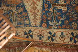 Geometric patterns in sky blue, madder red, ivory on an antique Afshar rug's worn fringed corner.