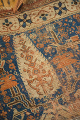 Mostly even wear on an antique Afshar rug, revealing sky blue and terra cotta tribal motifs.