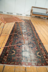 Vintage Lilihan runner showing indigo, dusty rose, teal geometric and curvilinear patterns with soft wear.