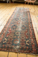 Visible wear on vintage Lilihan runner showcasing dusty rose and indigo geometric motifs.