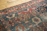 Lilihan runner detail: time-softened dusty rose, blue, green geometric patterns, with visible pile wear.