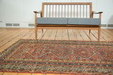 Antique Mission Malayer rug with dark terra cotta field and indigo blue floral motifs.