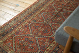 Antique Mission Malayer rug's terra cotta field with sea foam scalloped contours and floral patterns.