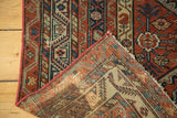 Antique Mission Malayer rug corner showing geometric pile, hand-knotted back, and secured red side.