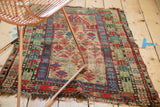 Detail of vintage Caucasian rug, geometric red, blue, green germinating flowers, visible knot heads.