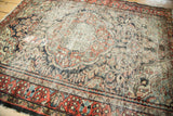 Vintage Dargezine rug corner with heavy wear, brick red border, and simplified floral field.