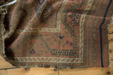 Geometric gul motifs on abrashed blush field with worn edge of antique Belouch rug.