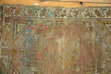 Oushak rug corner showing hexagonal spandrel, geometric border, and wear revealing foundation.