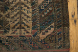 Antique Belouch rug detail: mostly even wear, knot heads, camel plant, madder red, navy barber pole border.