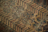 Hand-knotted antique Belouch rug tribal pattern with visible foundation in natural camel and earth tones.